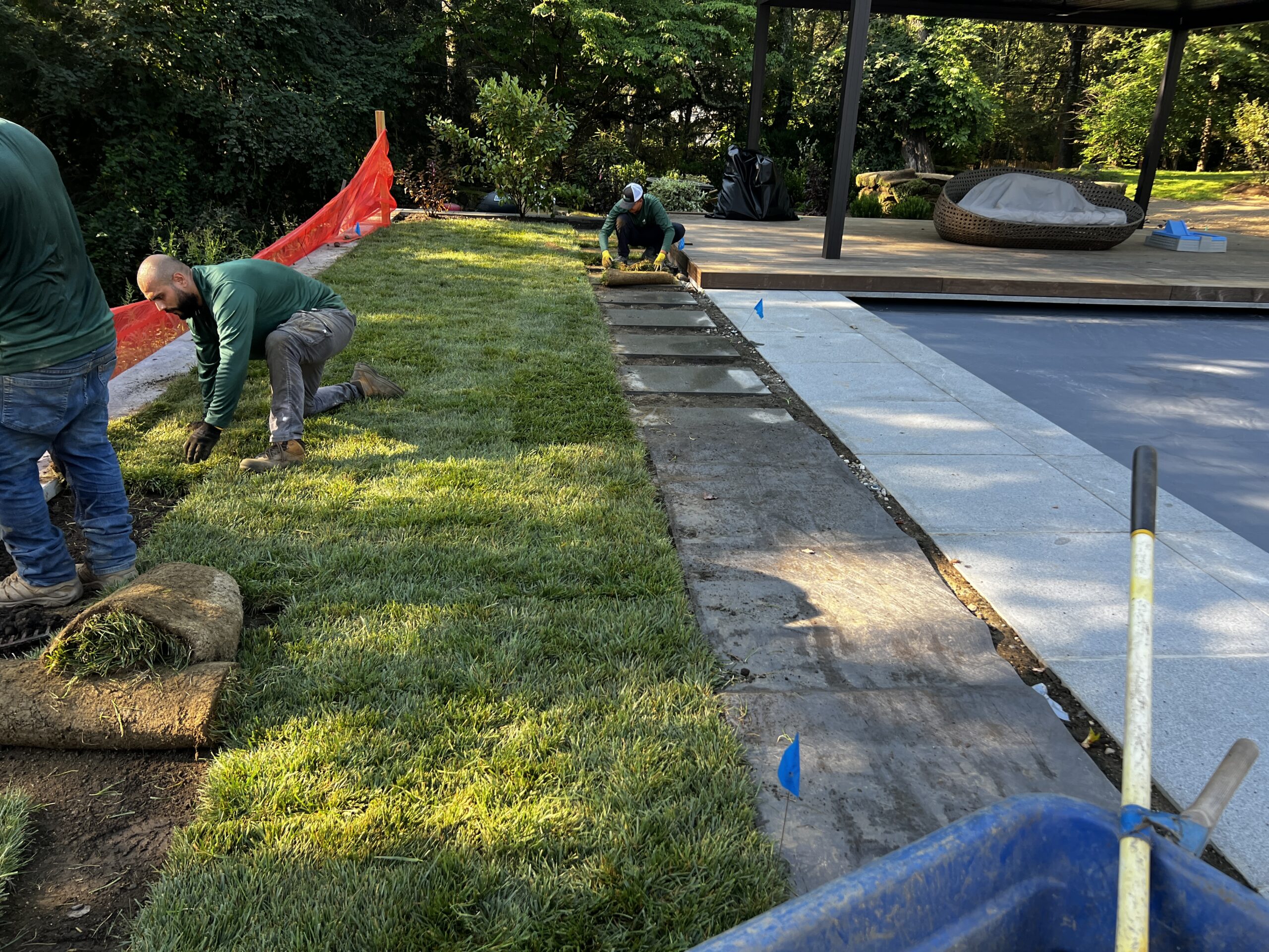 GJLD crews install sod with clover around the pool area to protect the newly build pool while construction continues.