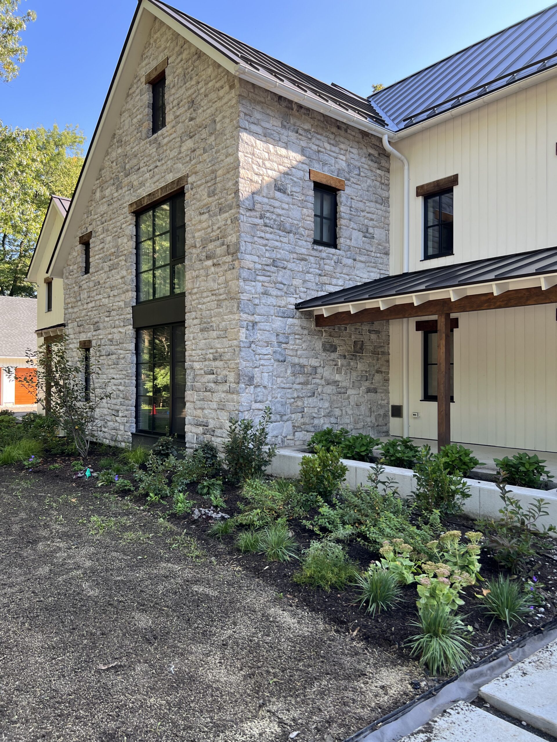 Front foundation planting features native shrubs, perennials and grasses for a layered habitat.
