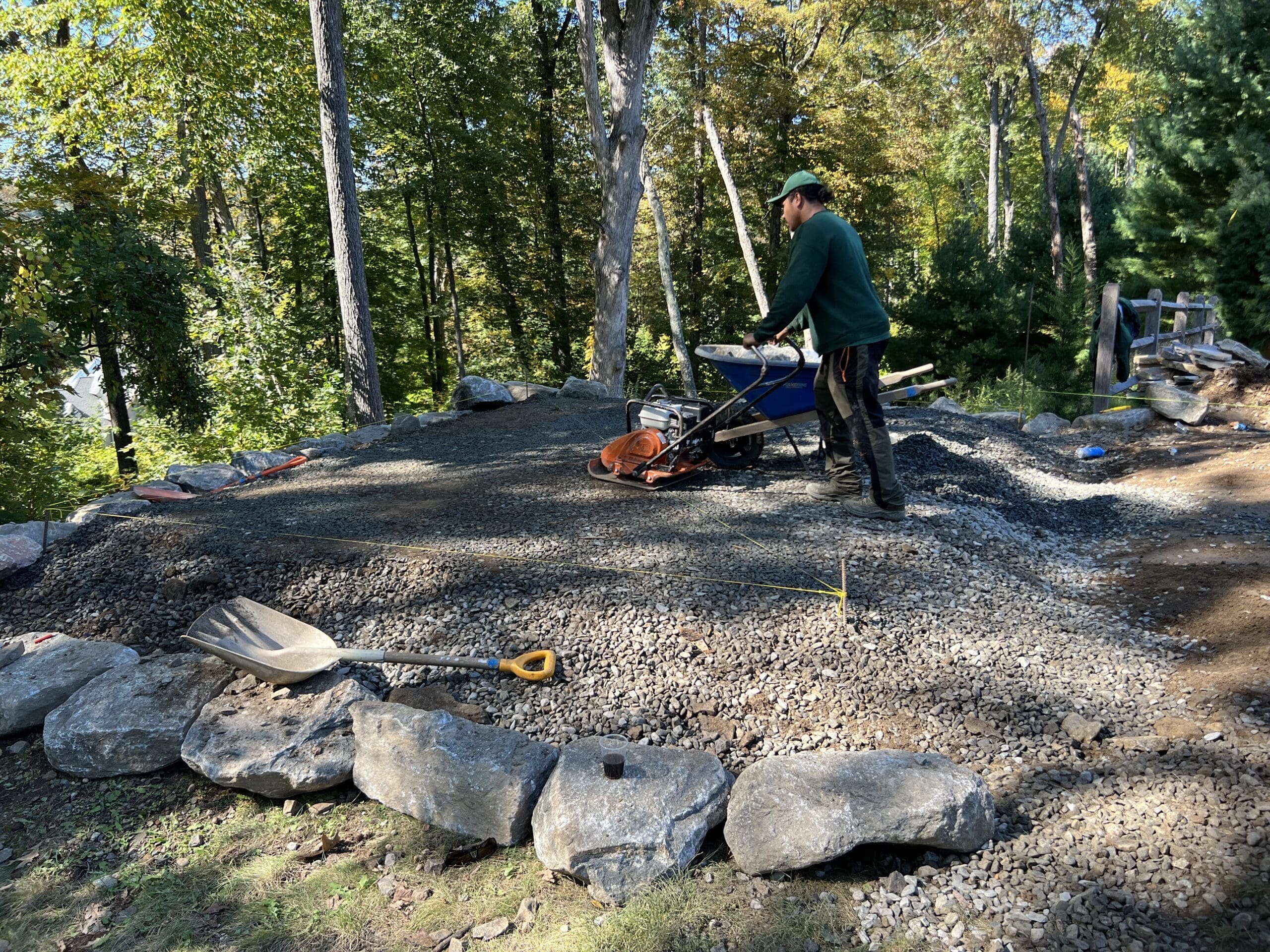 GJLD crew tamps the gravel of the new base for the shed. 